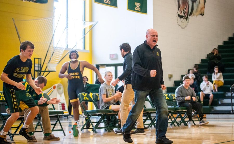 Coach K is fired up cheering on his Tiger wrestlers