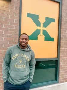 Coach Powell posing in front of his new school (Photo courtesy of St. X Football)