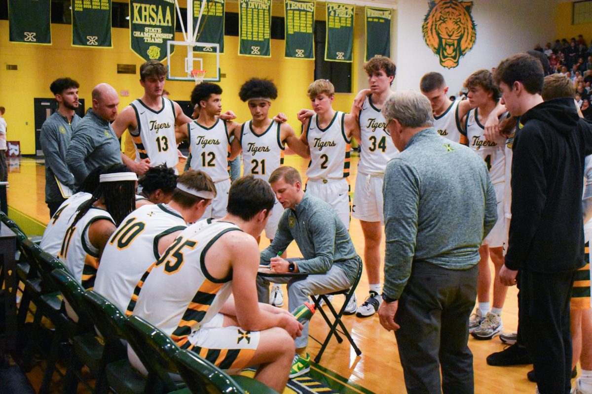 Coach Klein with his team in the huddle (Photo used with permission of Jack Bates)