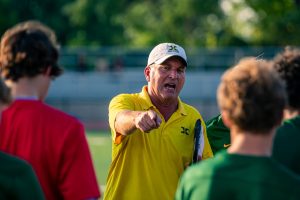 Coach Schulten giving directions to his team (photo used with permission from Jack Bates)