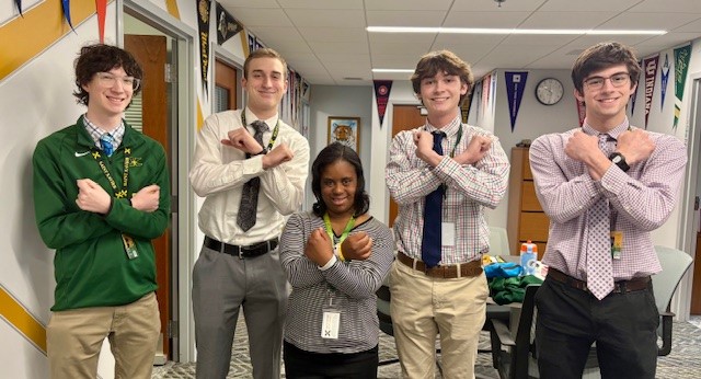 Bailee and current students putting up their X’s (photo courtesy of Mr. Ianke)