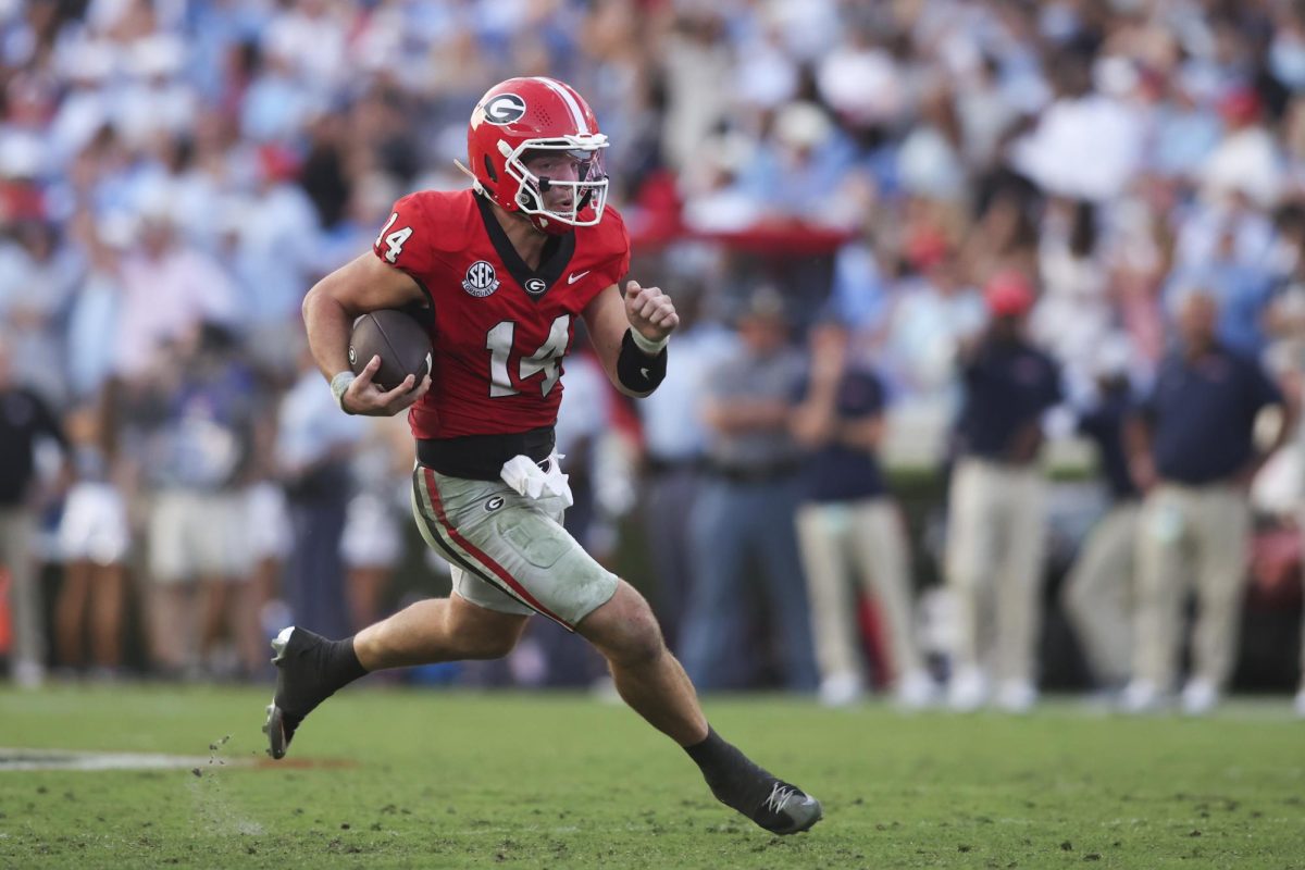 Oct 18, 2025; Athens, Georgia, USA;  Georgia Bulldogs quarterback Gunner Stockton (14) runs the ball against the Mississippi Rebels during the second half of the game at Sanford Stadium. Mandatory Credit: Brett Davis-Imagn Images