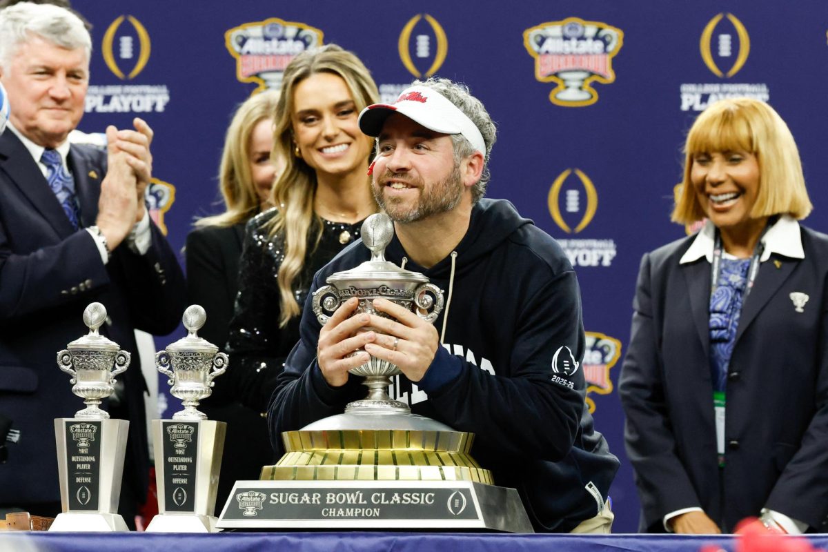 Jan 1, 2026; New Orleans, LA, USA; Mississippi Rebels head coach Pete Golding lifts the trophy after the 2025 Sugar Bowl and quarterfinal game of the College Football Playoff against the Georgia Bulldogs at Caesars Superdome. Mandatory Credit: Amber Searls-Imagn Images